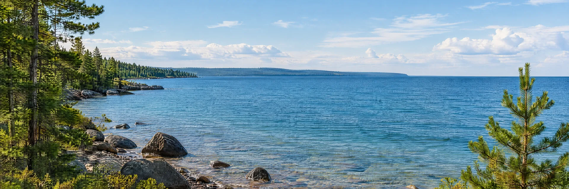 Illustration inspired by Mackinaw City, MI: great Lakes pebble shoreline with pines and broad blue water, no bridge.