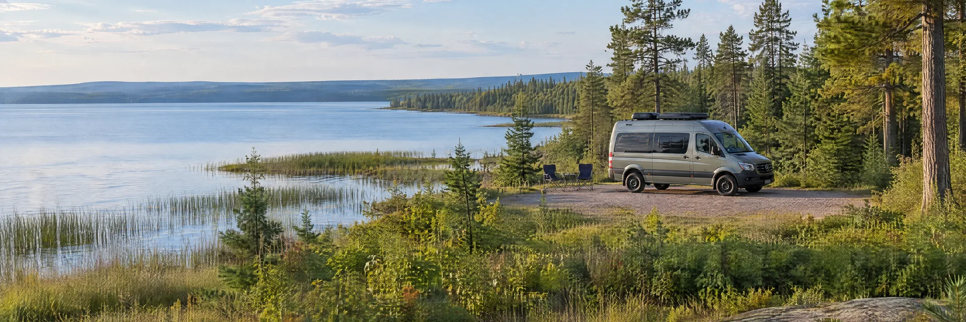 Illustration of a camper van at a fictional camping setting inspired by Saint Helen, MI.