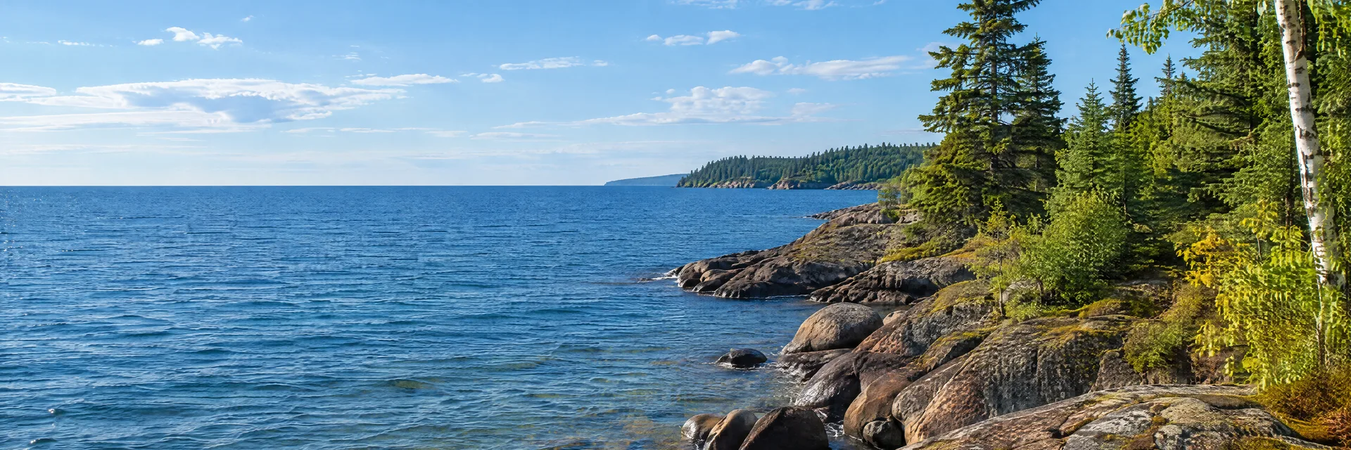 Illustration inspired by Schroeder, MN: minnesota North Shore Lake Superior rocky shoreline with spruce, birch, rounded stones and a deep blue freshwater horizon.