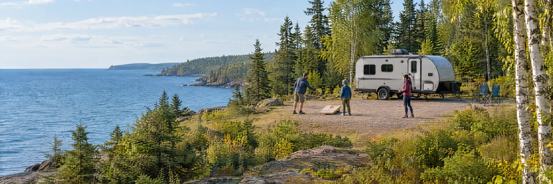 Illustration of campers enjoying family campsite activities beside a compact travel trailer in a fictional camping setting inspired by Two Harbors, MN.