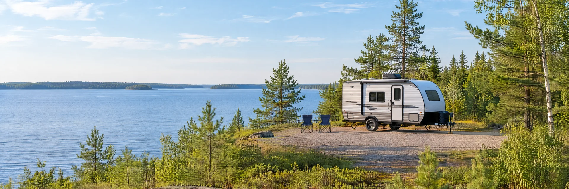 Illustration of a compact travel trailer at a fictional camping setting inspired by Walker, MN.