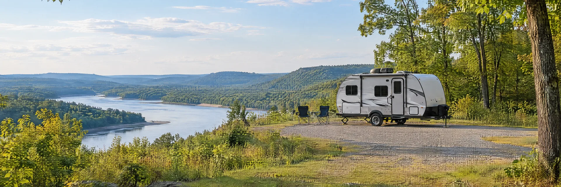 Illustration of a compact travel trailer at a fictional camping setting inspired by Poplar Bluff, MO.