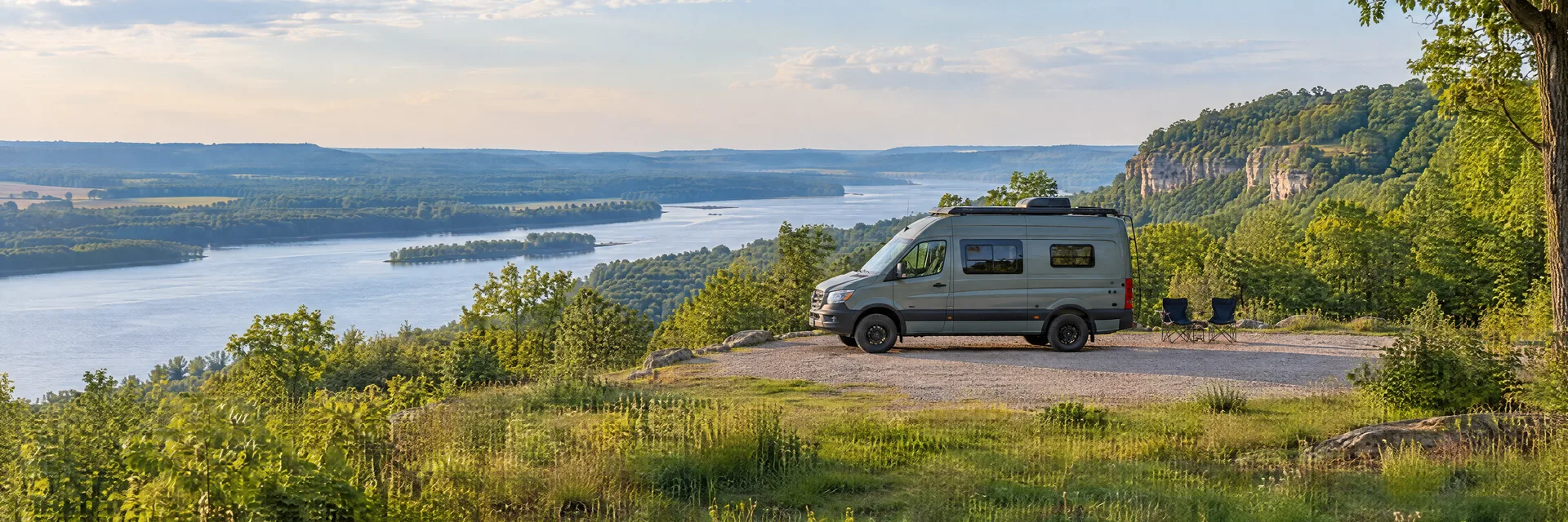 Illustration of a camper van at a fictional camping setting inspired by St. Louis, MO.