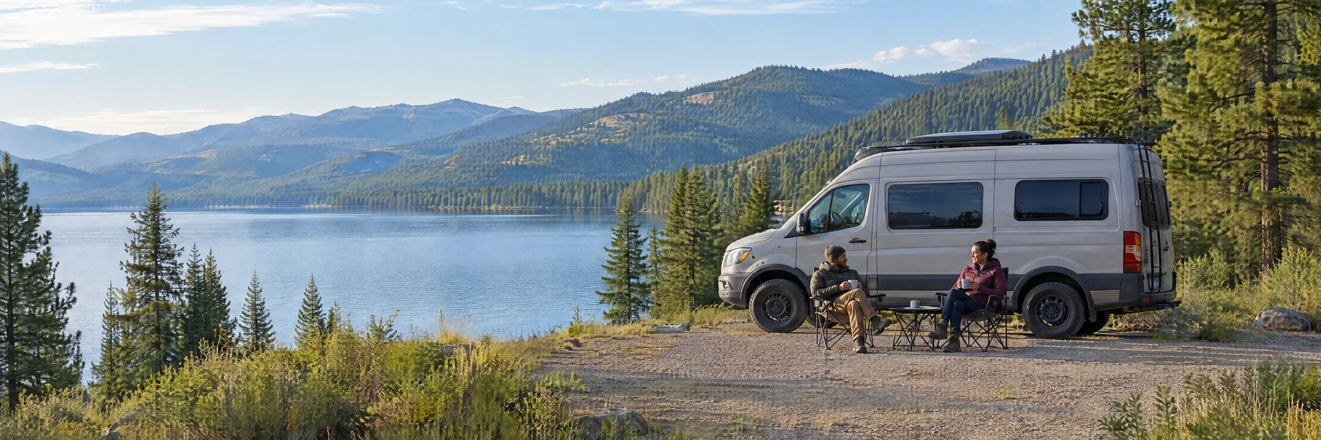 Illustration of campers enjoying morning coffee beside a camper van in a fictional camping setting inspired by Lake Mary Ronan, MT.