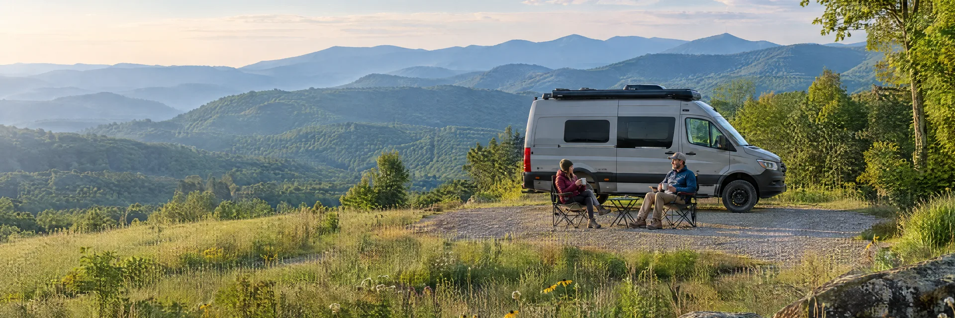 Illustration of campers enjoying morning coffee beside a camper van in a fictional camping setting inspired by Hendersonville, NC.
