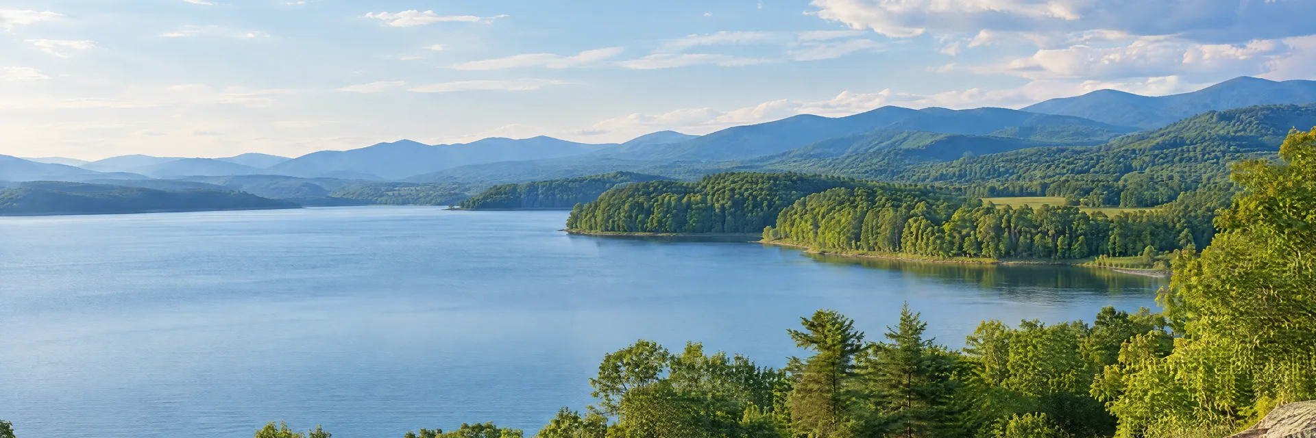 Illustration inspired by Morganton, NC: western North Carolina foothills, broad freshwater lake, gently rolling green shoreline and layered forested ridges.