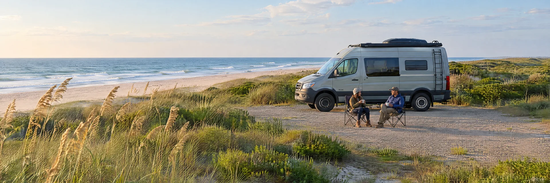 Illustration of campers enjoying morning coffee beside a camper van in a fictional camping setting inspired by Ocracoke, NC.