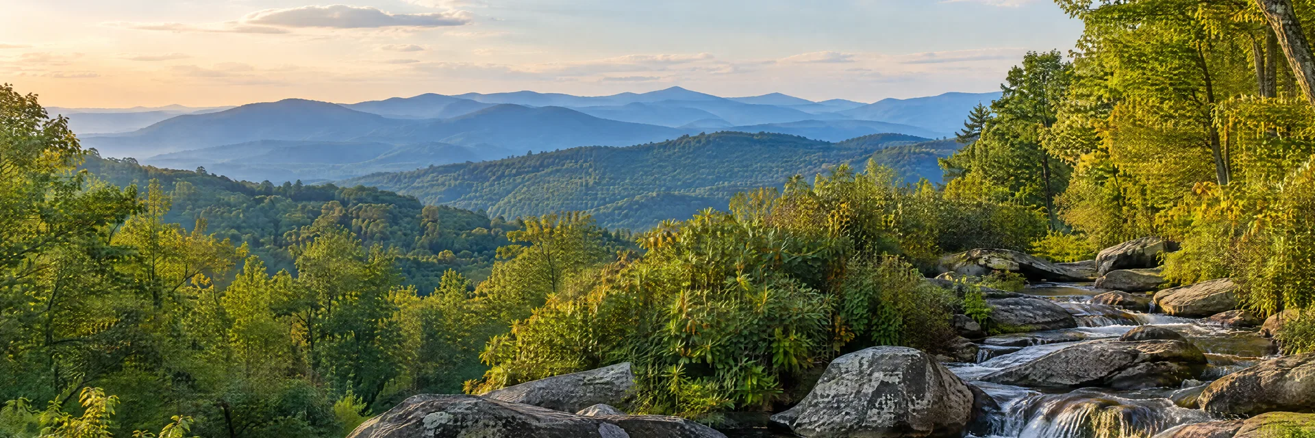 Illustration inspired by Spruce Pine, NC: blue Ridge foothills with hardwood forest, rocky mountain stream and layered hills.