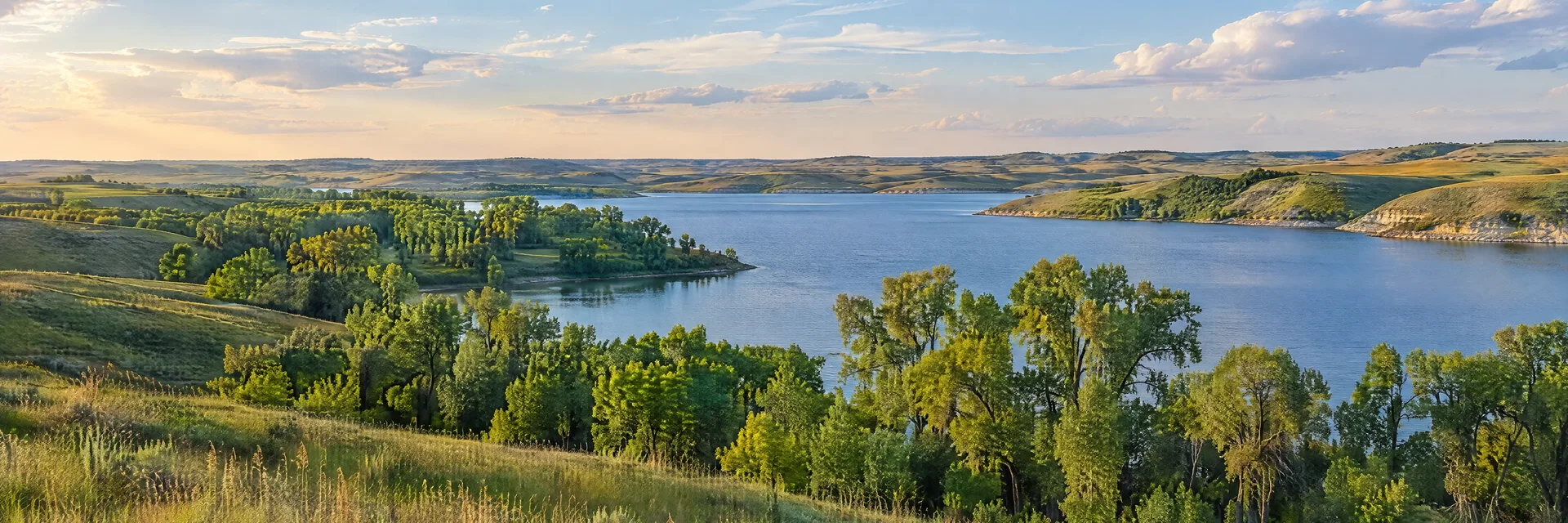 Illustration inspired by Lincoln, NE: eastern Nebraska prairie reservoir, cottonwood groves and rolling grassy hills.
