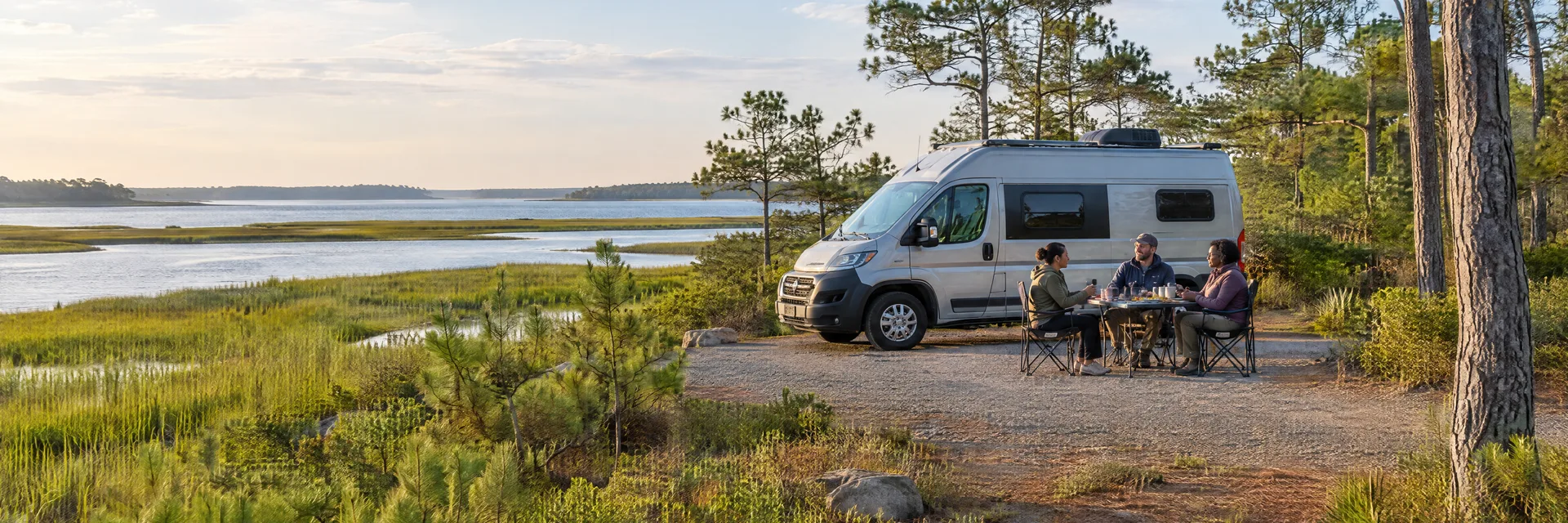 Illustration of campers enjoying an outdoor meal beside a camper van in a fictional camping setting inspired by Ocean View, NJ.