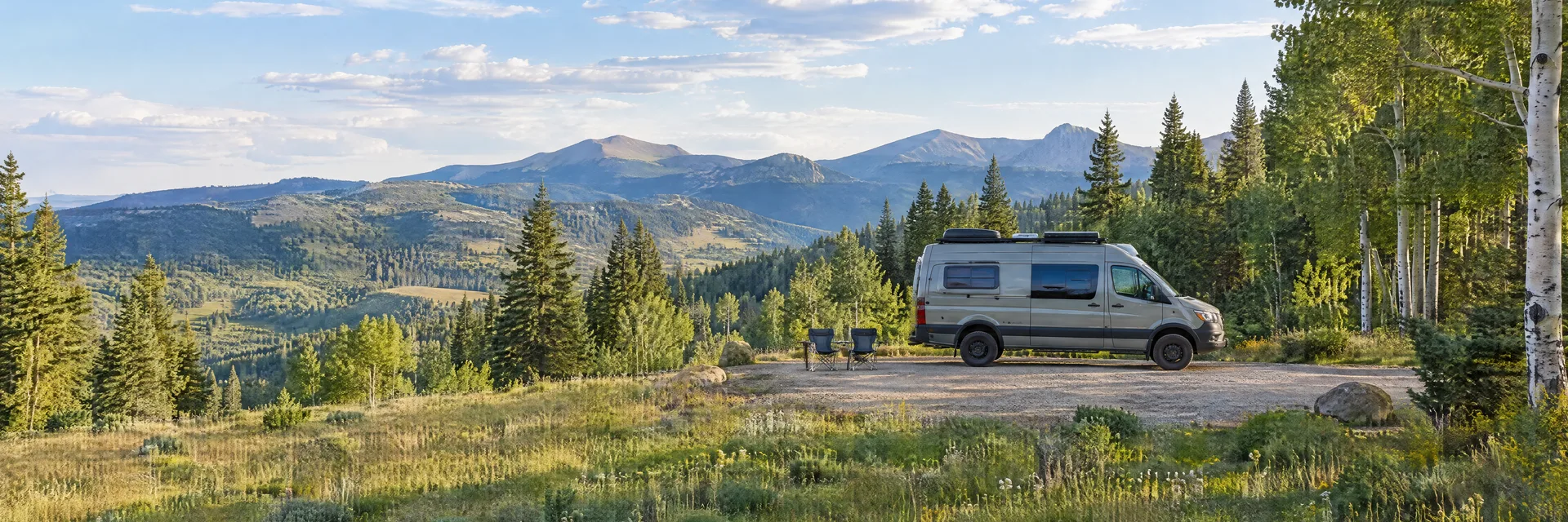 Illustration of a camper van at a fictional camping setting inspired by Angel Fire, NM.