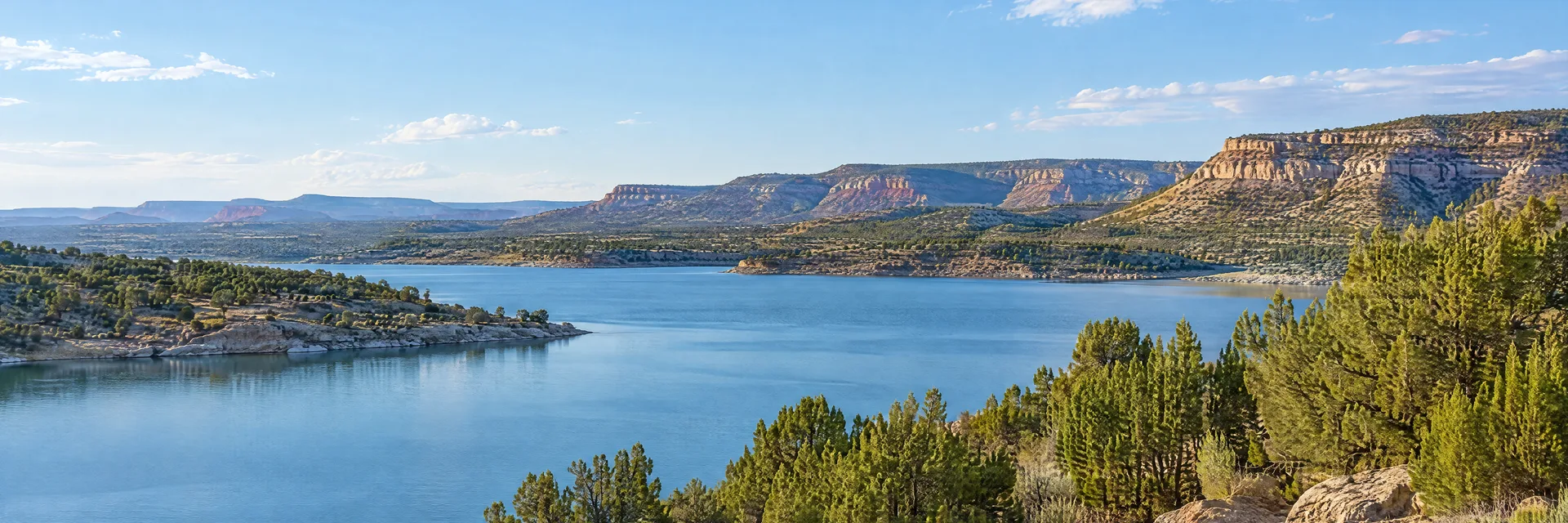 Illustration inspired by Bluewater, NM: western New Mexico high desert lake bordered by juniper and low rocky mesas.
