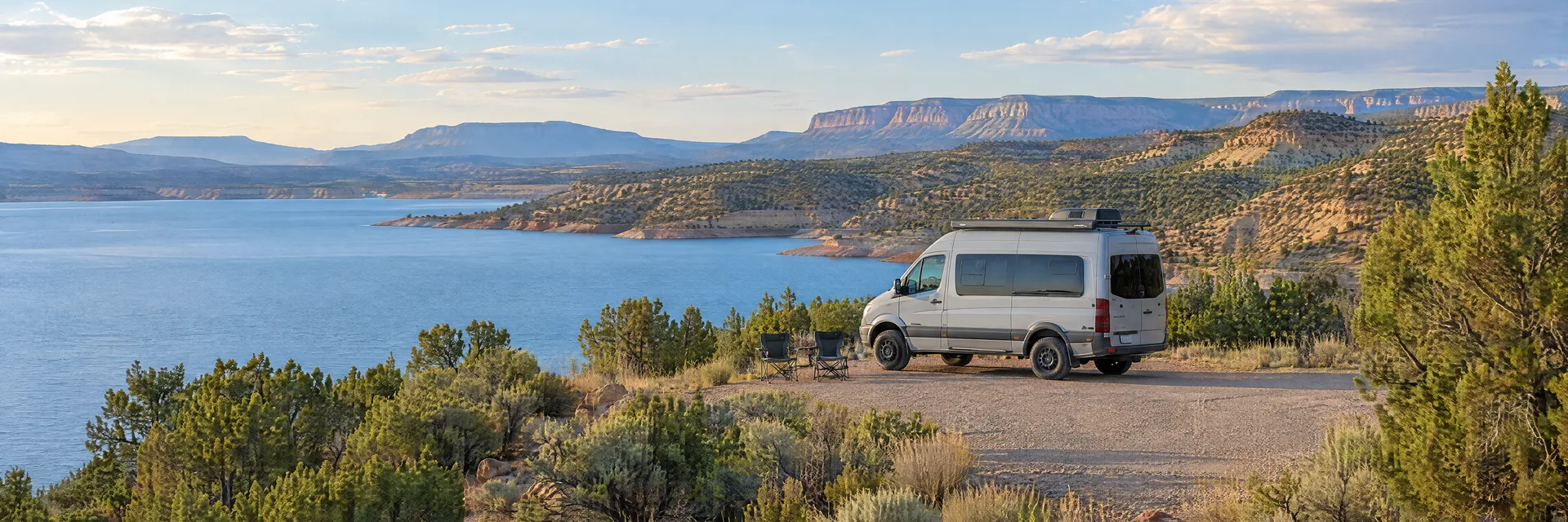 Illustration of a camper van at a fictional camping setting inspired by Cochiti Lake, NM.
