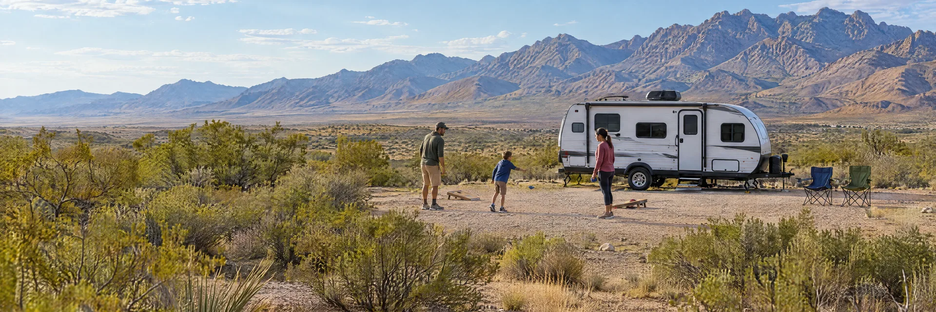 Illustration of campers enjoying family campsite activities beside a compact travel trailer in a fictional camping setting inspired by Las Cruces, NM.