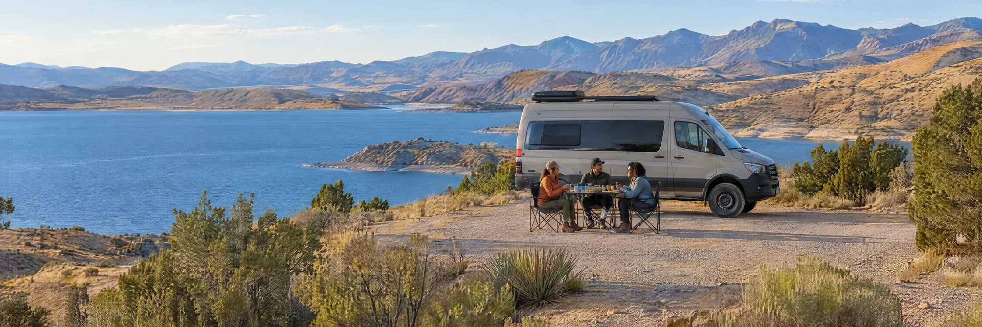 Illustration of campers enjoying an outdoor meal beside a camper van in a fictional camping setting inspired by Truth Or Consequences, NM.