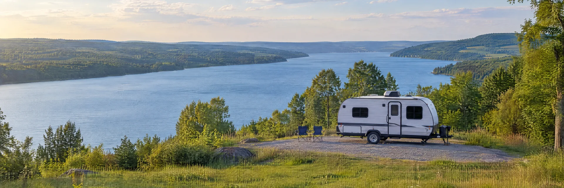 Illustration of a compact travel trailer at a fictional camping setting inspired by Canandaigua, NY.