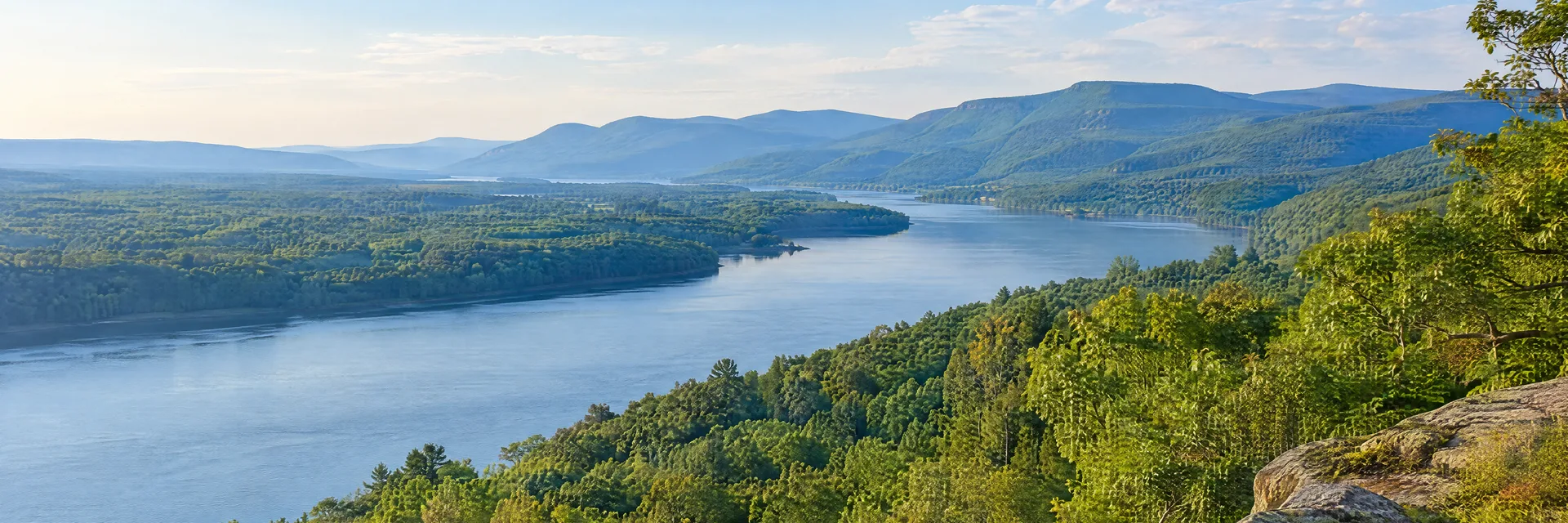 Illustration inspired by Catskill, NY: new York Hudson Valley river corridor, hardwood forest and distant Catskill ridges.
