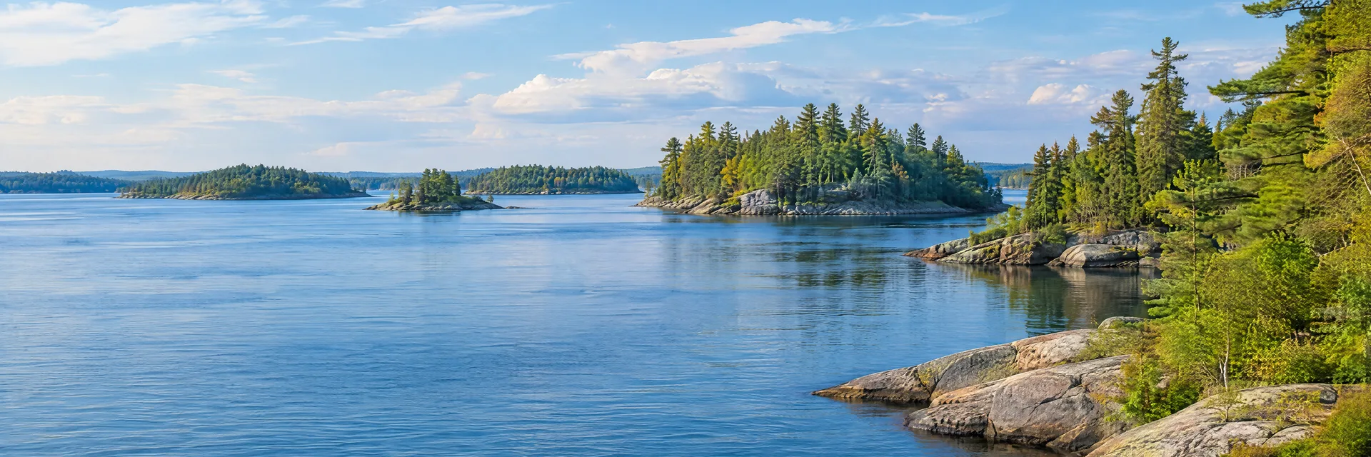 Illustration inspired by CLAYTON, NY: st. Lawrence River broad blue channel, granite shoreline and wooded islands.