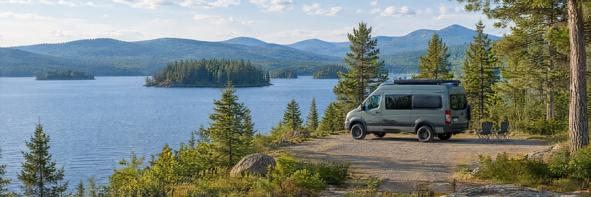 Illustration of a camper van at a fictional camping setting inspired by RAQUETTE LAKE, NY.