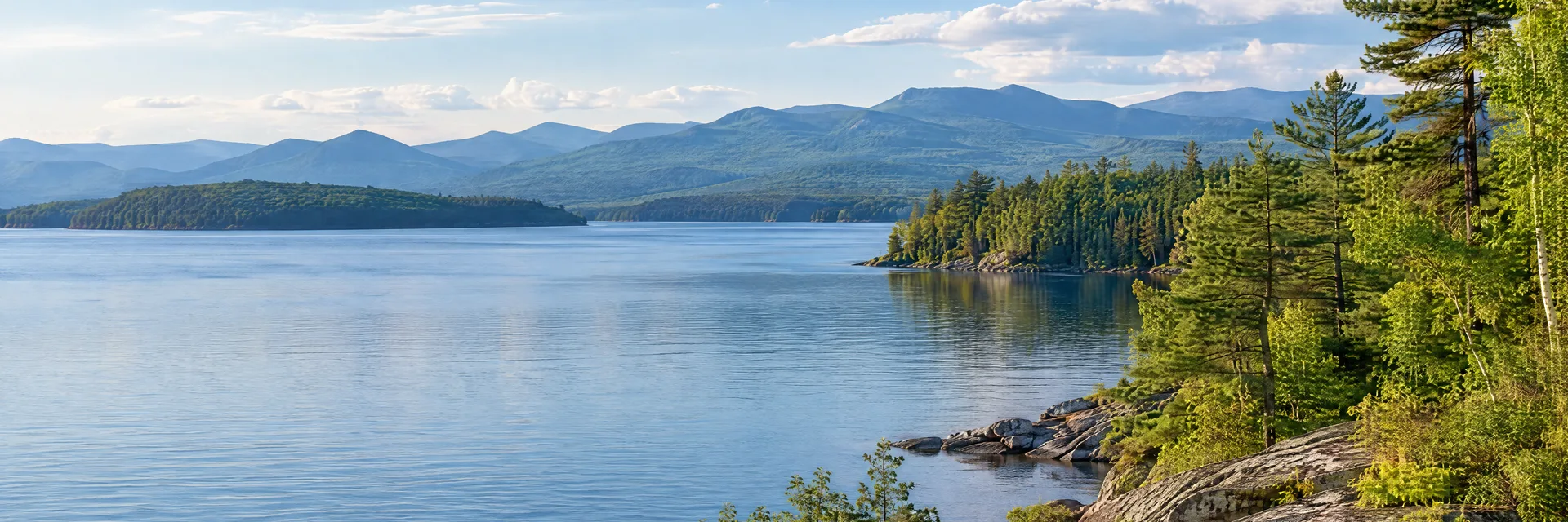 Illustration inspired by Ticonderoga, NY: northern New York lakeshore, hardwood forest and distant Adirondack ridges.