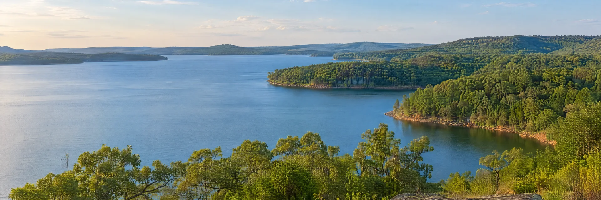 Illustration inspired by Checotah, OK: eastern Oklahoma broad reservoir, wooded coves and gently rolling oak-covered hills.