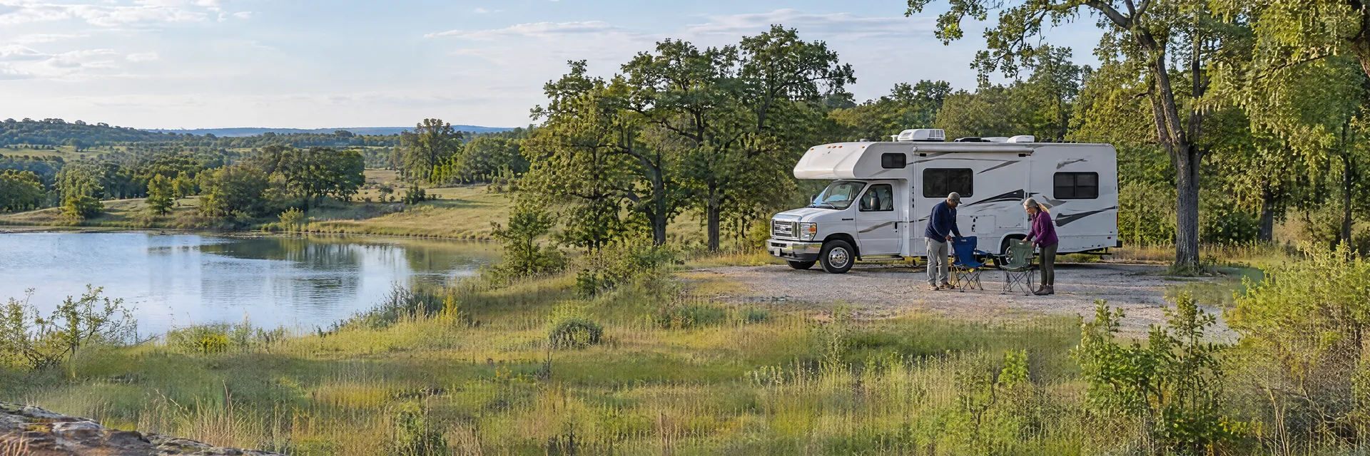 Illustration of campers enjoying setting up camp beside a Class C motorhome in a fictional camping setting inspired by Choctaw, OK.