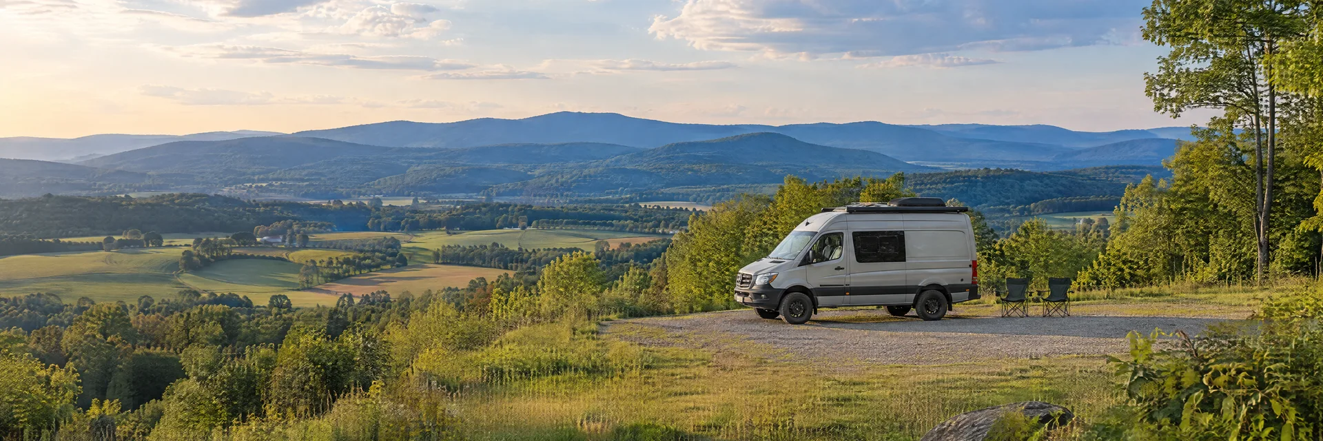 Illustration of a camper van at a fictional camping setting inspired by CARLISLE, PA.