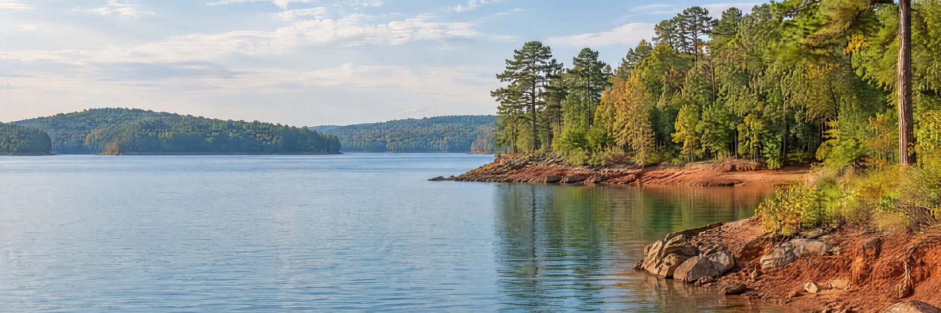 Illustration inspired by Mccormick, SC: western South Carolina broad freshwater reservoir cove with red clay shore, pines and mixed hardwood forest.