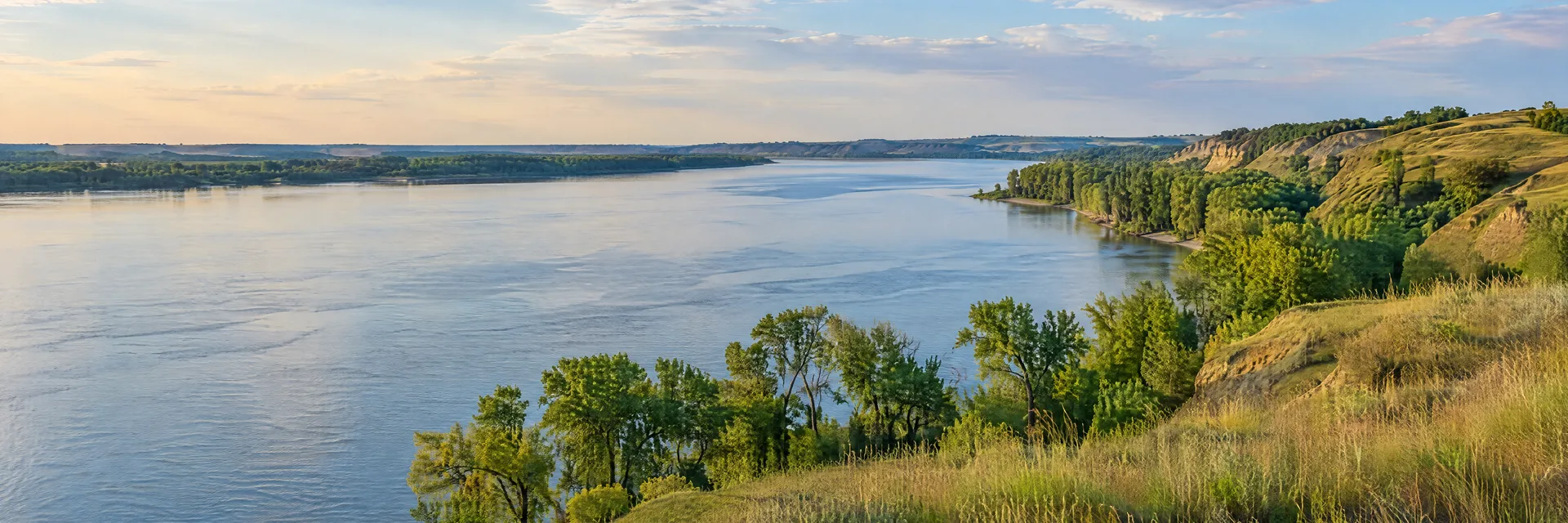 Illustration inspired by Yankton, SD: south Dakota broad Missouri River water, grassy bluffs and cottonwood shoreline.