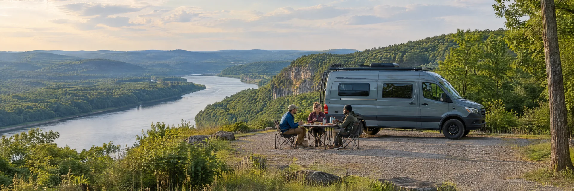 Illustration of campers enjoying an outdoor meal beside a camper van in a fictional camping setting inspired by Clarksville, TN.