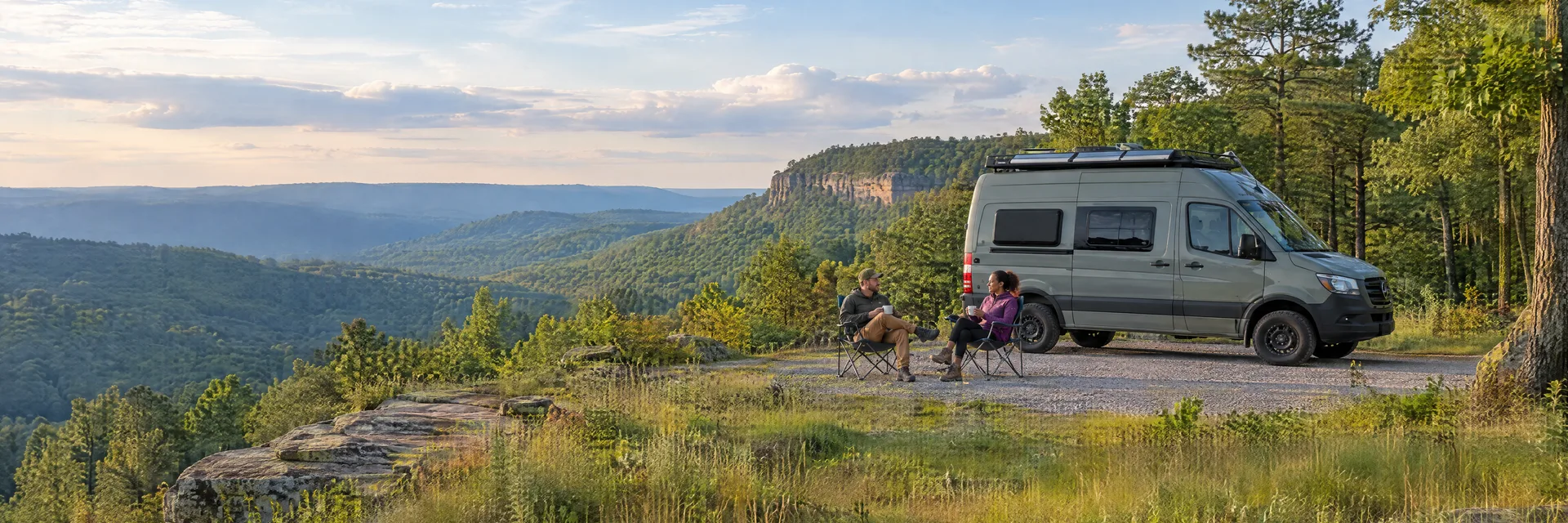 Illustration of campers enjoying morning coffee beside a camper van in a fictional camping setting inspired by Jamestown, TN.