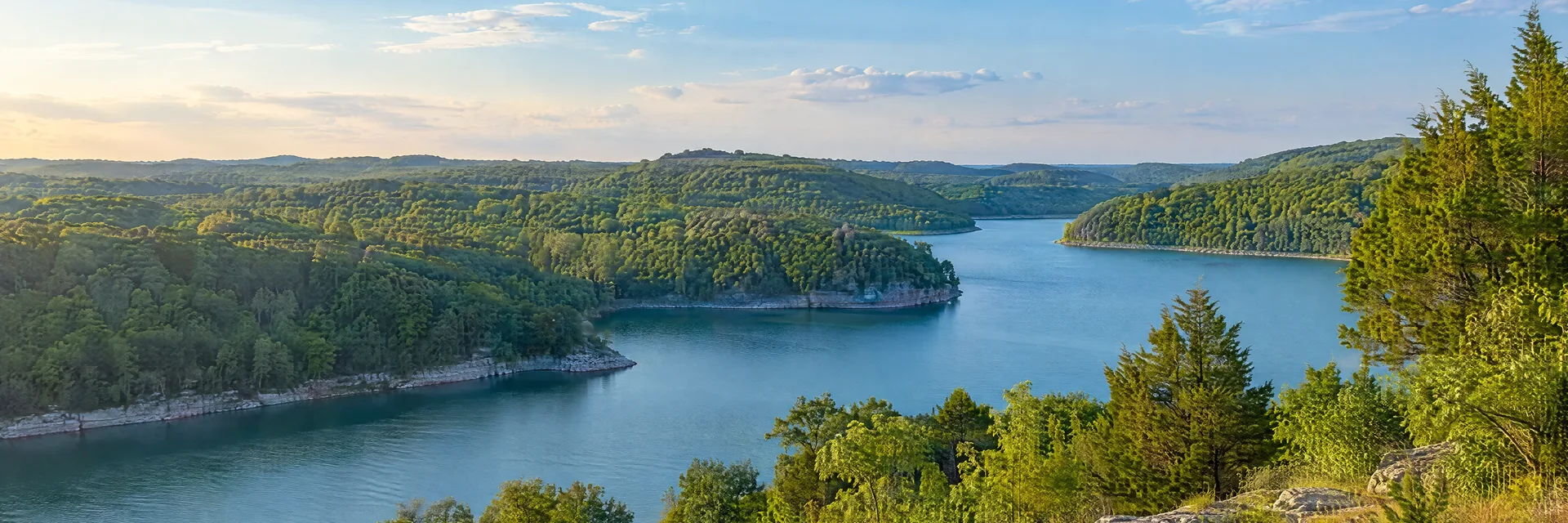 Illustration inspired by Lebanon, TN: middle Tennessee countryside, rolling limestone hills, cedar and hardwood groves and a quiet blue reservoir cove.