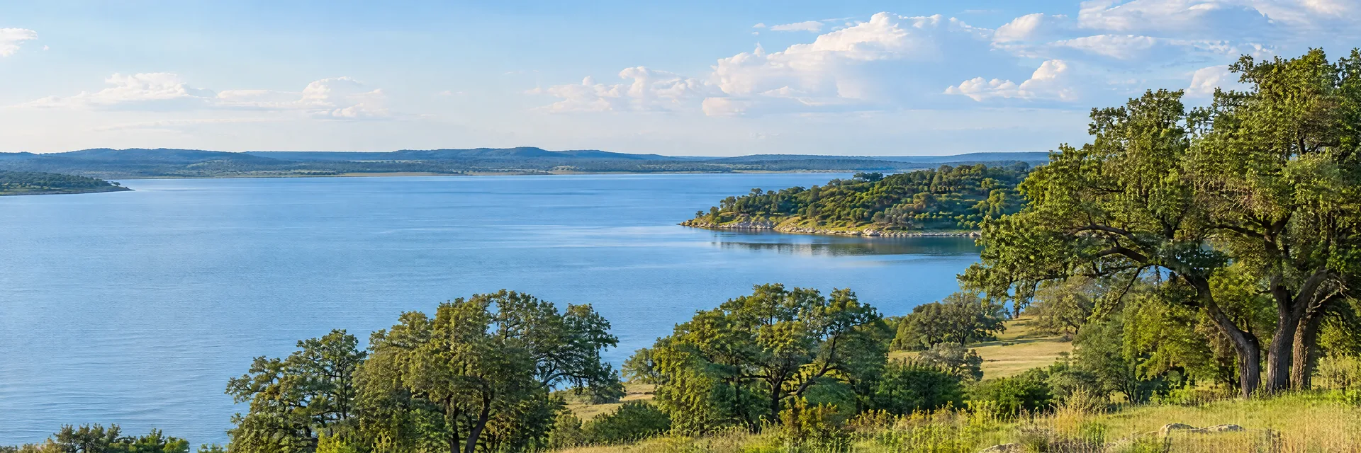 Illustration inspired by Azle, TX: north Texas reservoir with oak groves, gently rolling grassland and calm blue water.