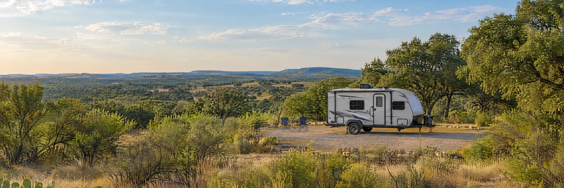 Illustration of a compact travel trailer at a fictional camping setting inspired by Beeville, TX.