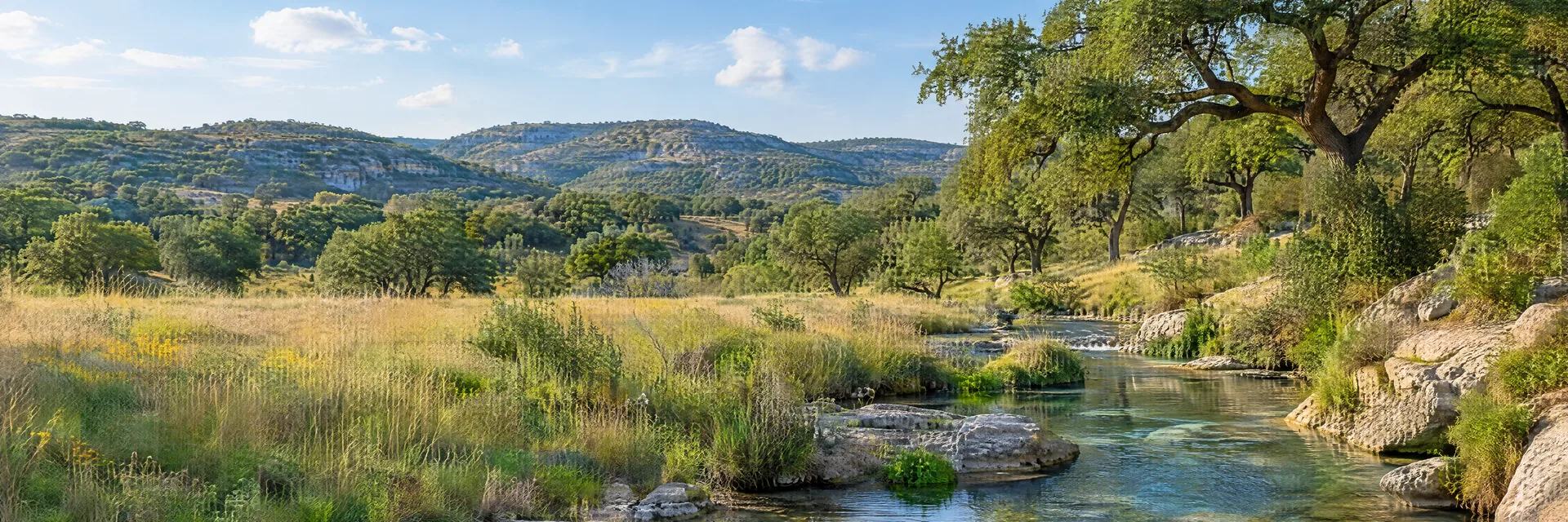Illustration inspired by Boerne, TX: texas Hill Country, rolling limestone hills, live oak groves, native grass meadow and a clear spring-fed creek.