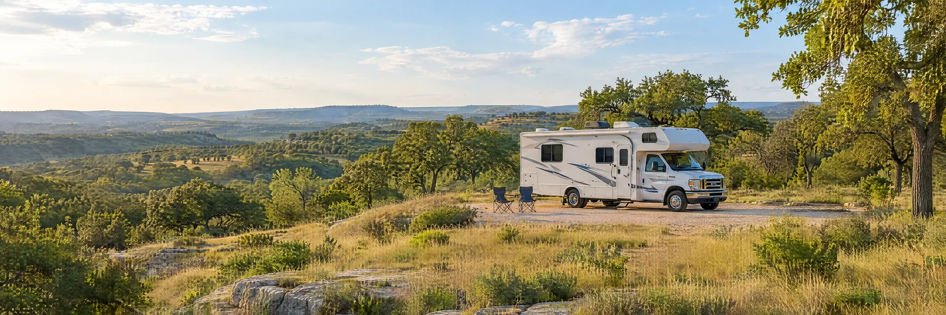 Illustration of a Class C motorhome at a fictional camping setting inspired by Buda, TX.