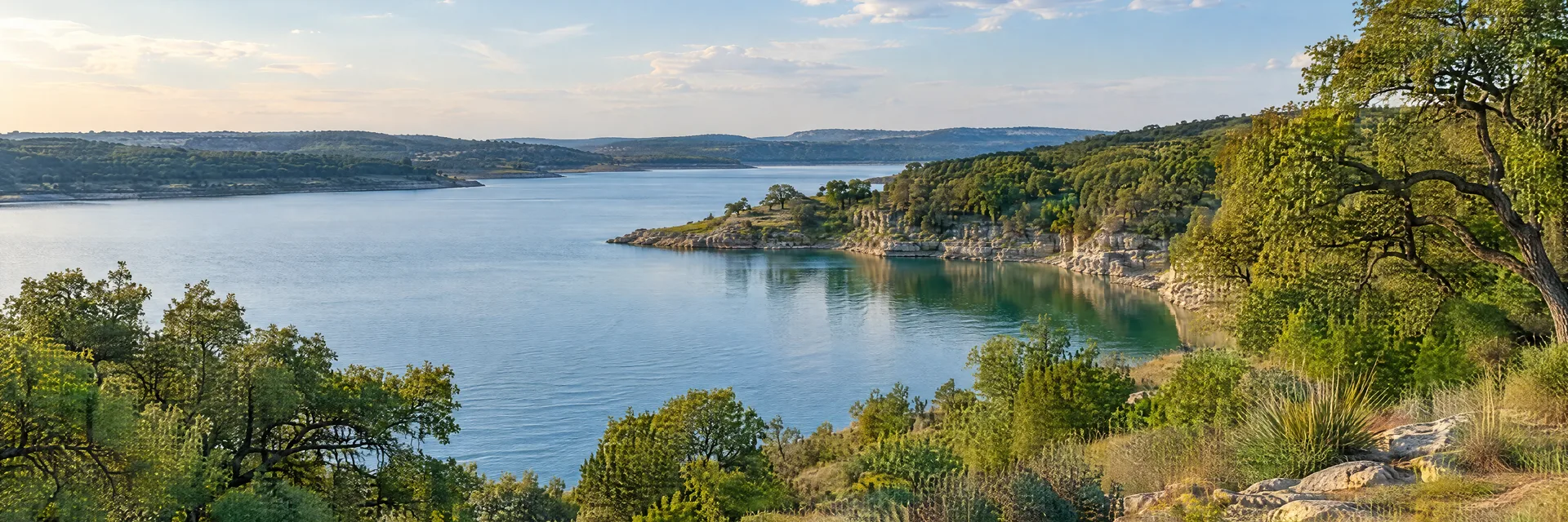 Illustration inspired by Cleburne, TX: north Texas limestone countryside, oak woods and a calm lake inlet.