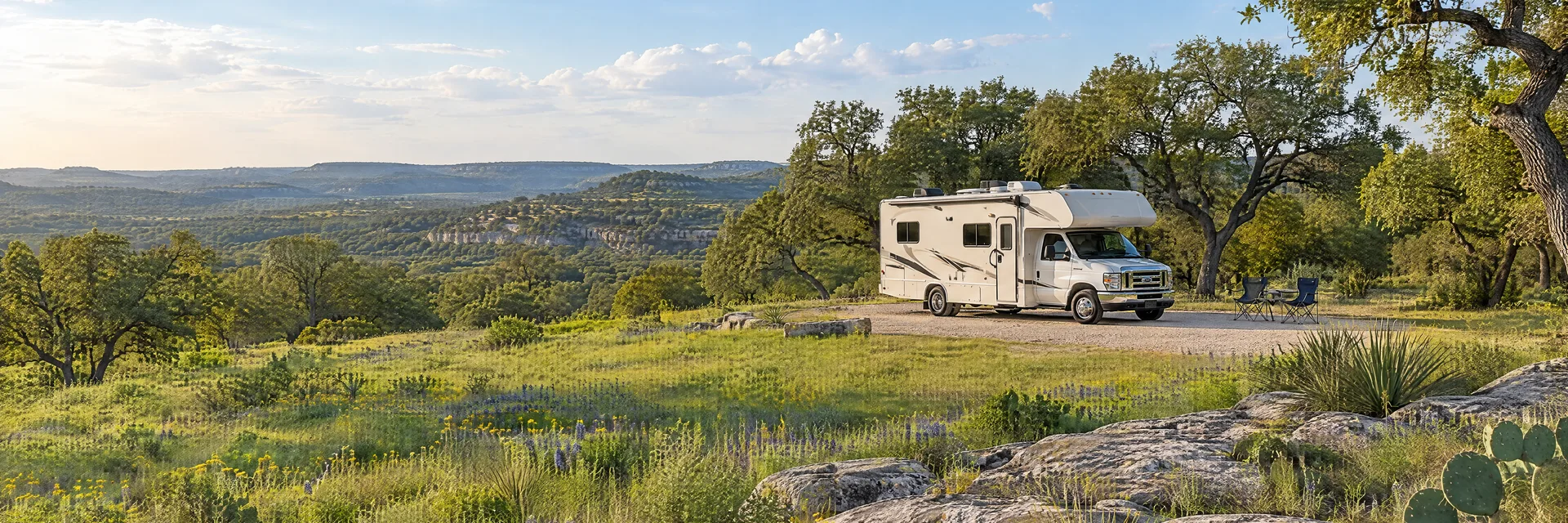 Illustration of a Class C motorhome at a fictional camping setting inspired by Driftwood, TX.