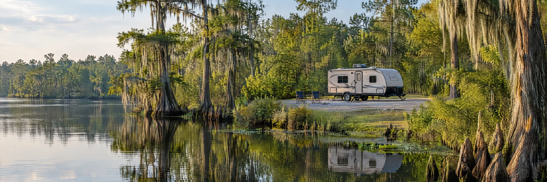 Illustration of a compact travel trailer at a fictional camping setting inspired by Jefferson, TX.