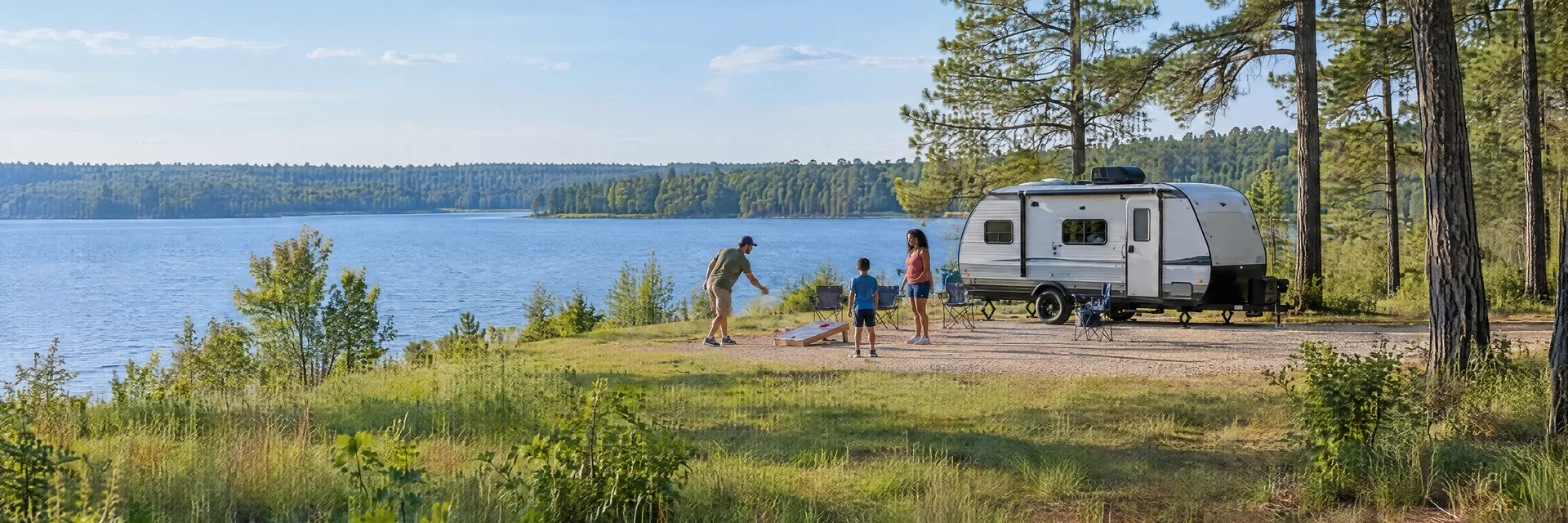 Illustration of campers enjoying family campsite activities beside a compact travel trailer in a fictional camping setting inspired by Pineland, TX.