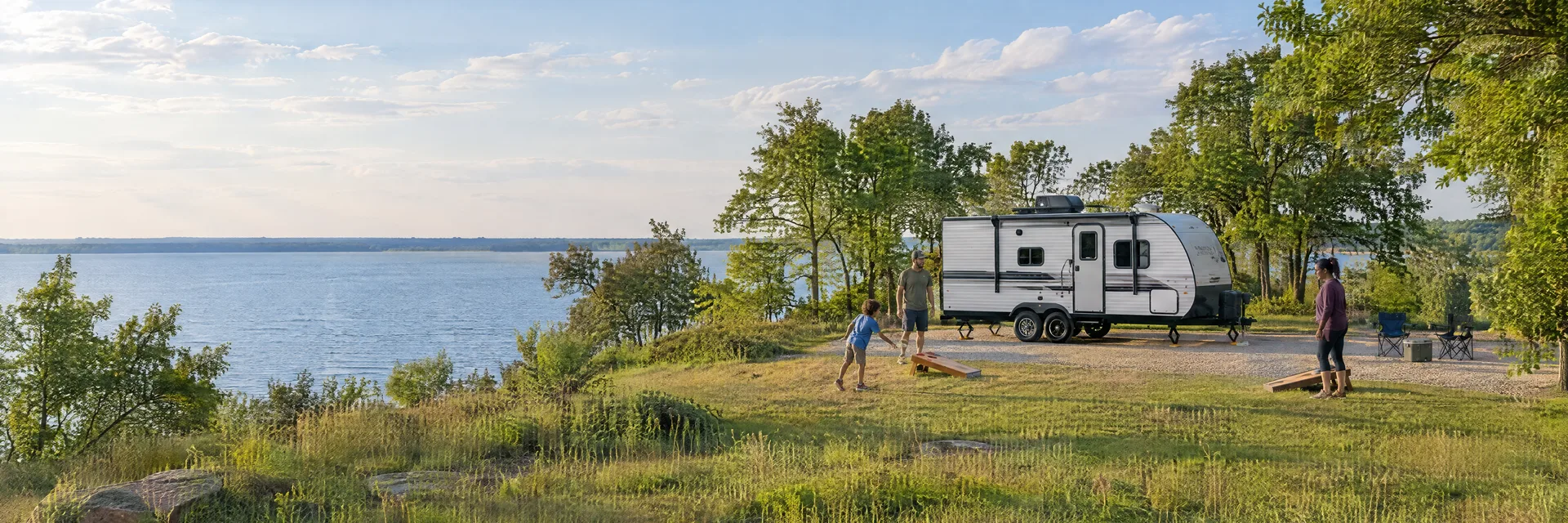 Illustration of campers enjoying family campsite activities beside a compact travel trailer in a fictional camping setting inspired by Wylie, TX.
