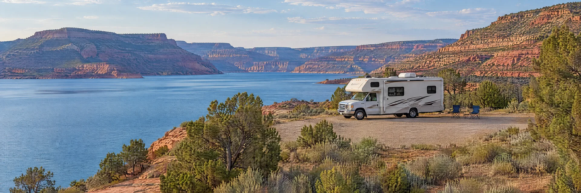 Illustration of a Class C motorhome at a fictional camping setting inspired by Flaming Gorge, UT.