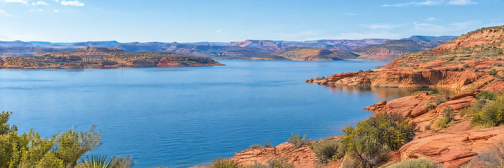 Illustration inspired by Gunlock, UT: southwestern Utah desert lake country, clear blue reservoir, red sandstone slopes and scattered desert shrubs, no named landmark formation.