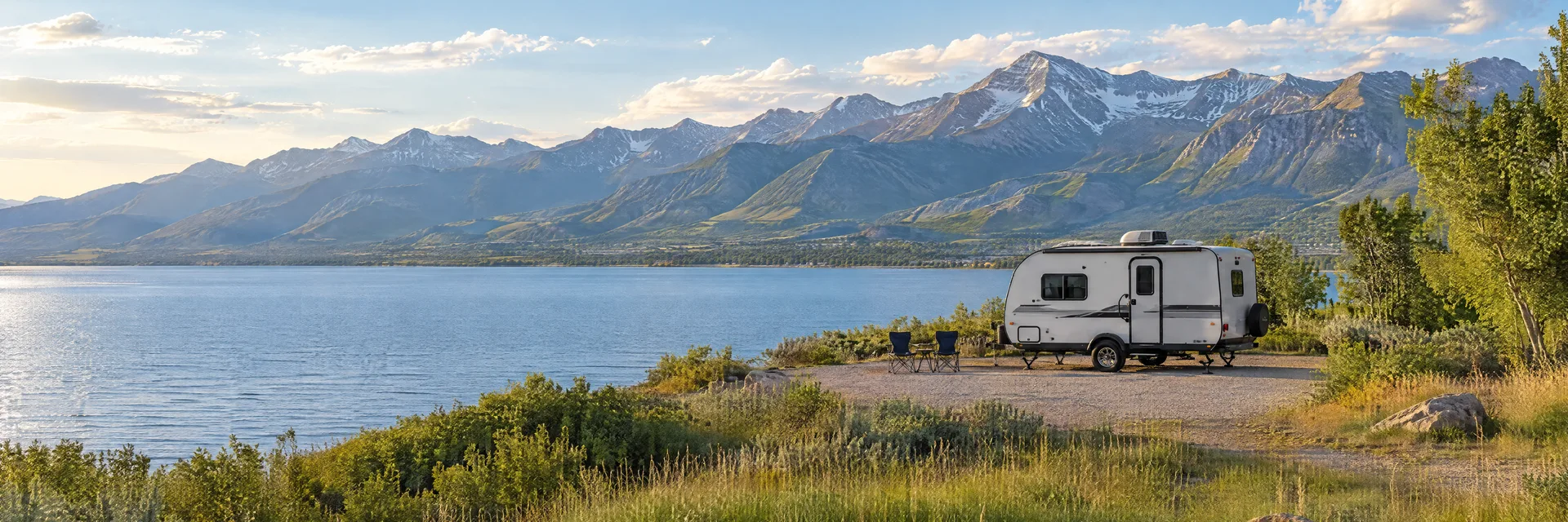 Illustration of a compact travel trailer at a fictional camping setting inspired by Provo, UT.