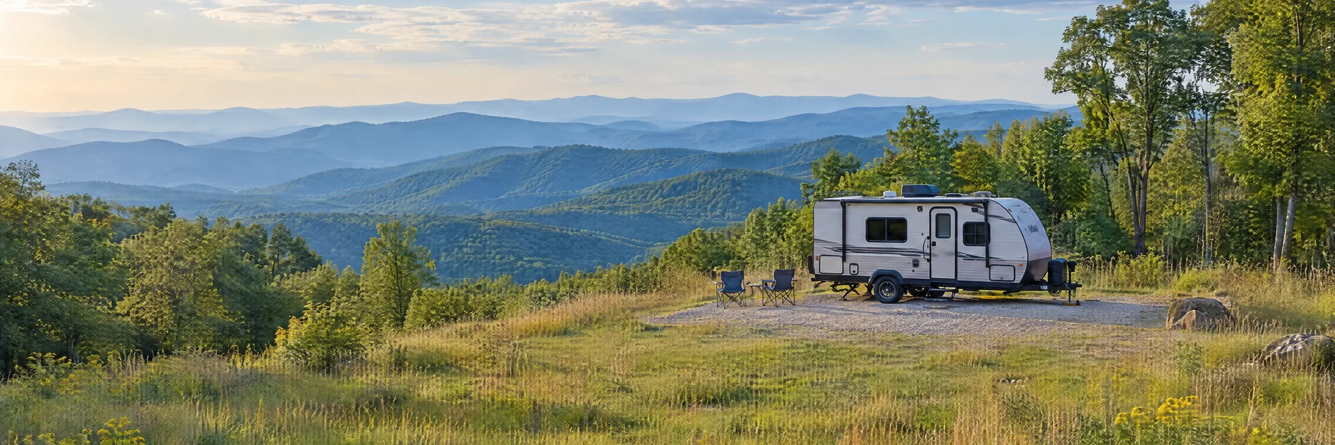Illustration of a compact travel trailer at a fictional camping setting inspired by Fancy Gap, VA.