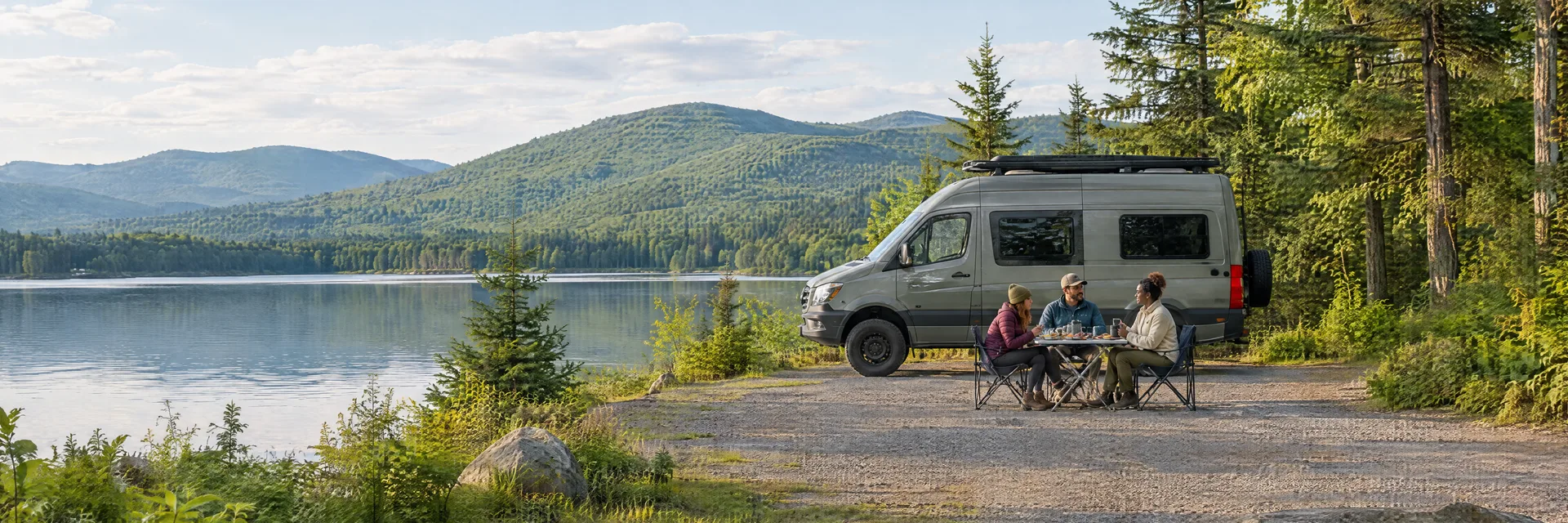 Illustration of campers enjoying an outdoor meal beside a camper van in a fictional camping setting inspired by Elmore, VT.