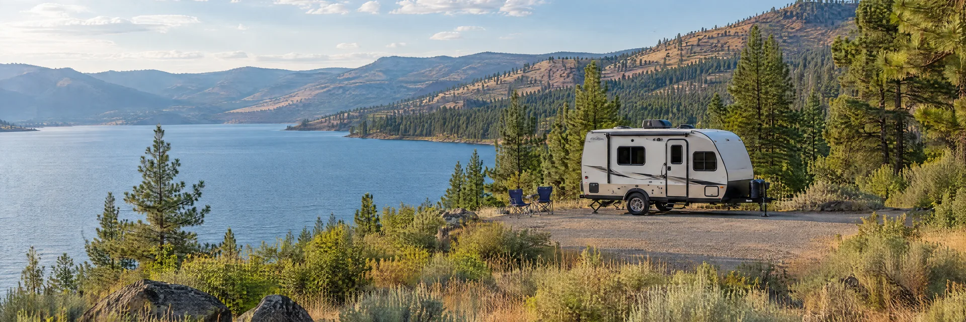 Illustration of a compact travel trailer at a fictional camping setting inspired by Boyds, WA.