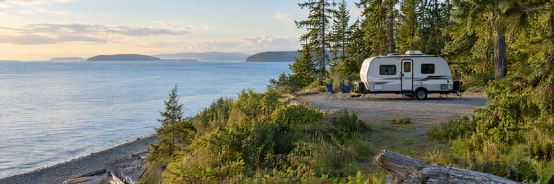 Illustration of a compact travel trailer at a fictional camping setting inspired by Camano Island, WA.
