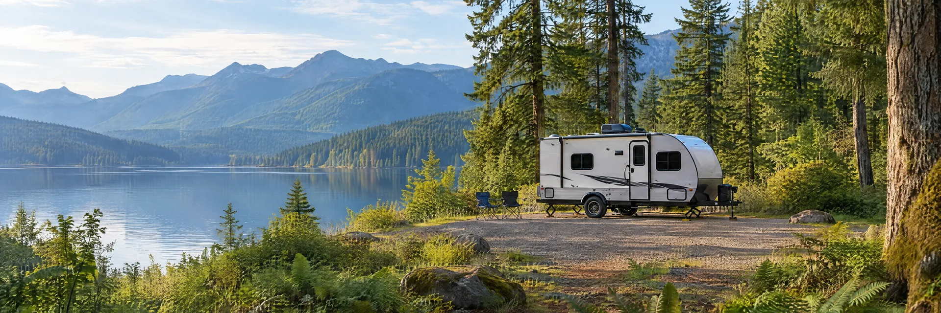 Illustration of a compact travel trailer at a fictional camping setting inspired by Issaquah, WA.