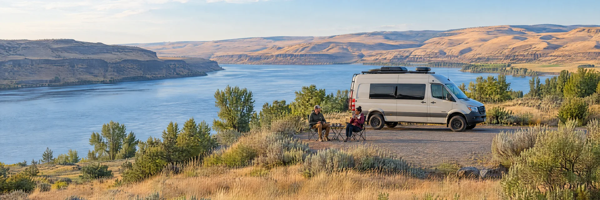 Illustration of campers enjoying morning coffee beside a camper van in a fictional camping setting inspired by Richland, WA.